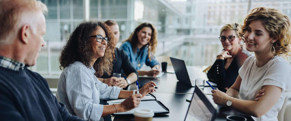 Diverse professional team having a collaborative business meeting in a bright office.